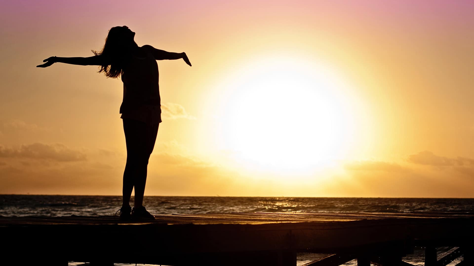 silhouette woman beach sunset